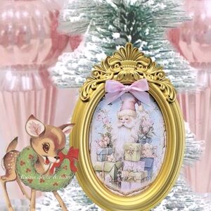 Gold vintage looking ornate frame with pink santa .